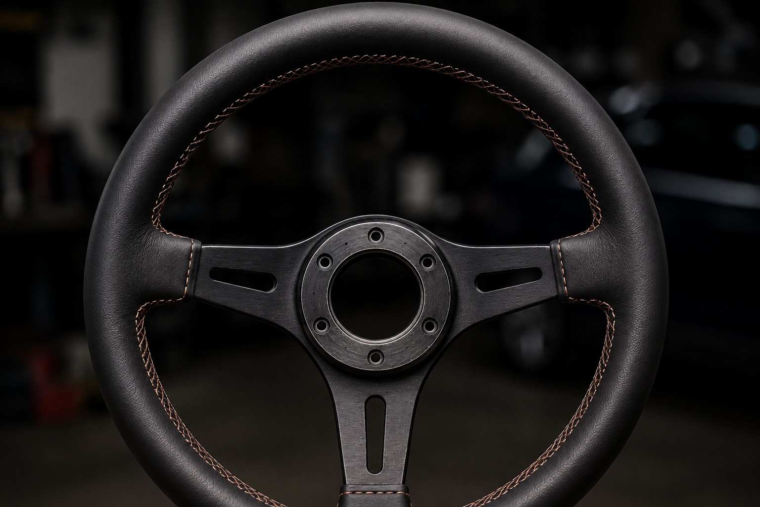 After: repaired leather steering wheel with clean contrast stitching